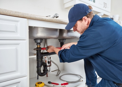 plumber working on a kitchen sink